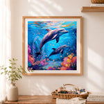 Finished two dolphins underwater coral reef cross stitch artwork displayed as home decor