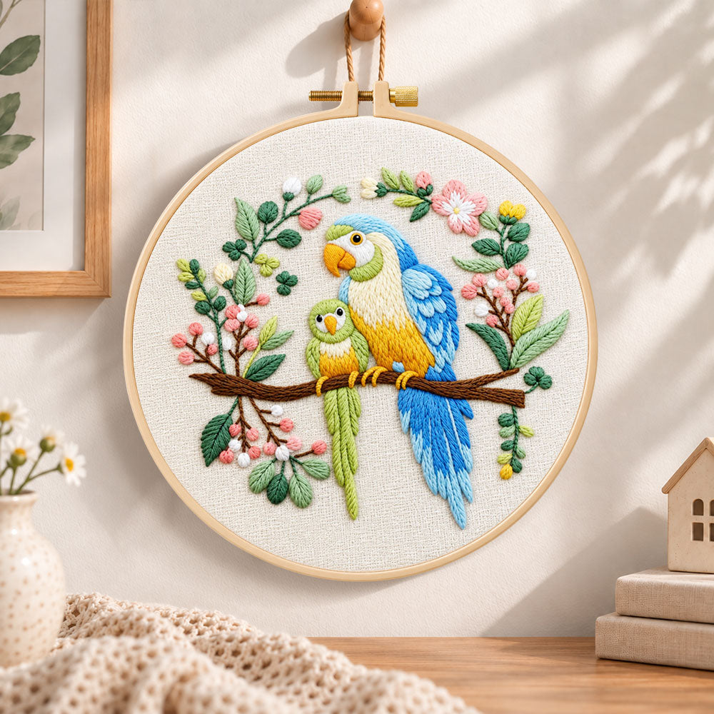 Two parrots on blossom branch embroidery hoop wall art displayed as warm and cozy handmade home decor