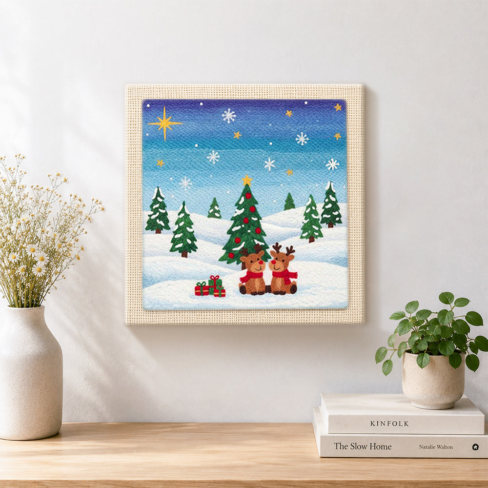 Finished two reindeers in snow artwork displayed on a wall