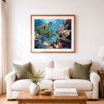 Finished two sea turtles in vibrant coral reef cross stitch artwork displayed as home decor
