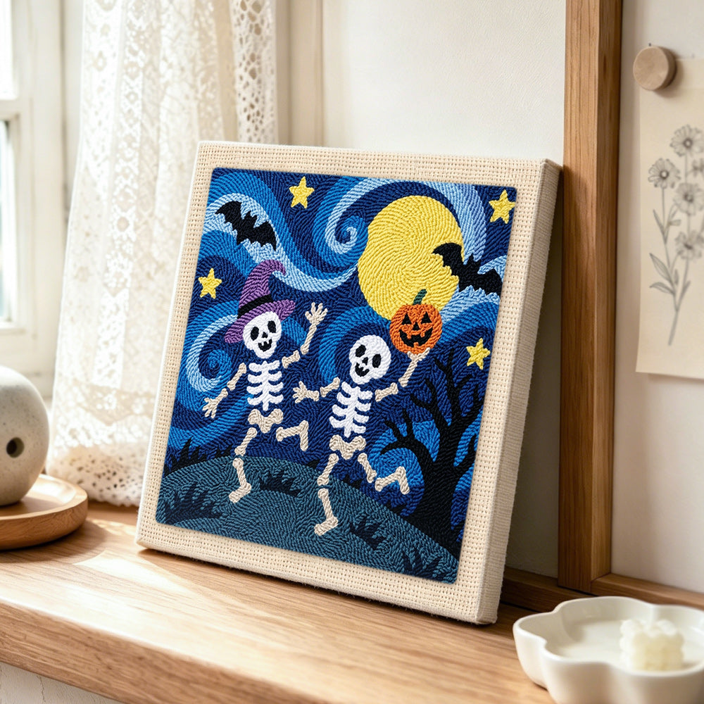 Two skeletons dancing at night punch needle artwork displayed on a table