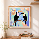 Finished two toucans on tropical branch cross stitch artwork displayed as home decor