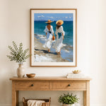 Finished two women in white dresses walking on beach cross stitch artwork displayed as home decor