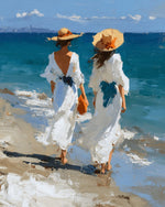 Two women in white dresses walking on beach cross stitch kit for beginners