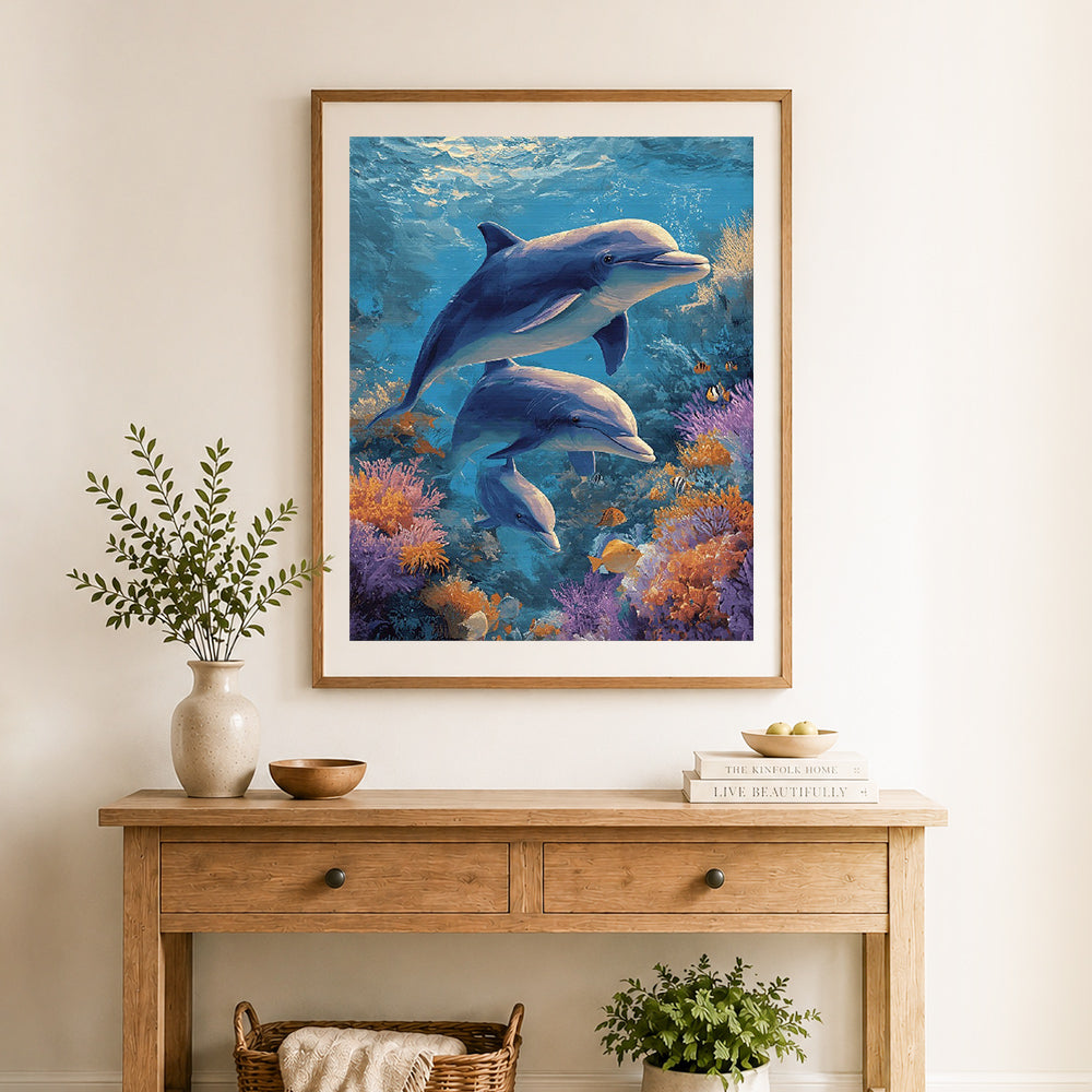 Finished underwater dolphin family cross stitch artwork displayed as home decor