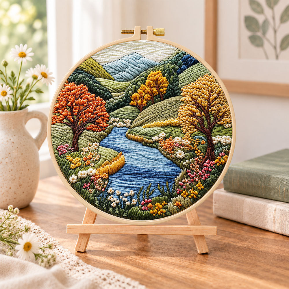 Valley river autumn scenery embroidery kit finished hoop displayed on a wooden stand as cozy tabletop decor