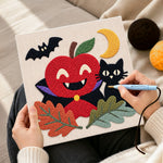 Creating handmade vampire apple and black cat punch needle artwork