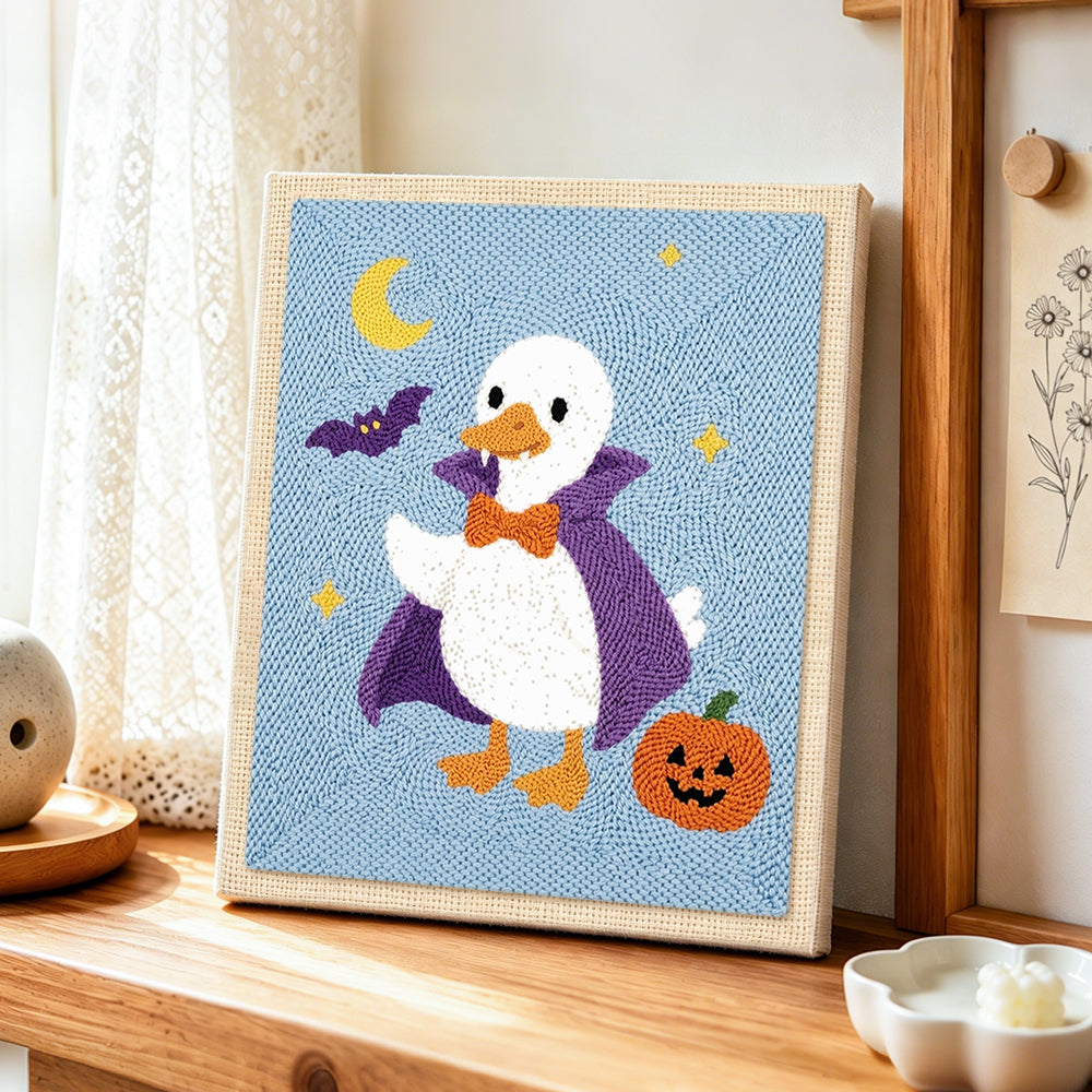Vampire duck halloween style punch needle artwork displayed on a table