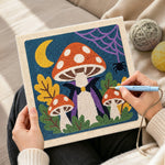 Creating handmade vampire mushroom under crescent moon punch needle artwork