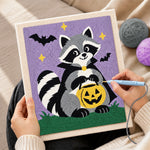 Creating handmade vampire raccoon with pumpkin bucket punch needle artwork