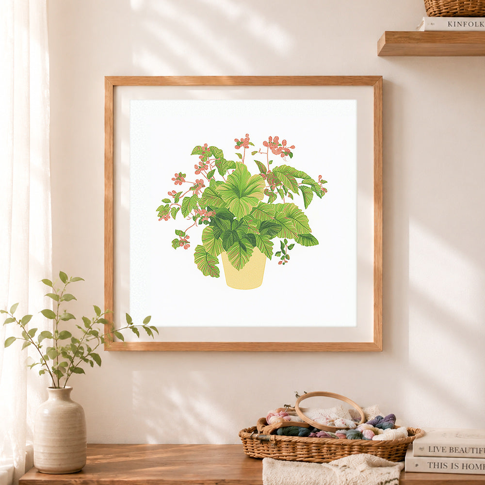 Finished variegated foliage potted plant cross stitch artwork displayed as home decor
