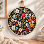 Vibrant bird floral scene embroidery hoop wall art displayed as warm and cozy handmade home decor