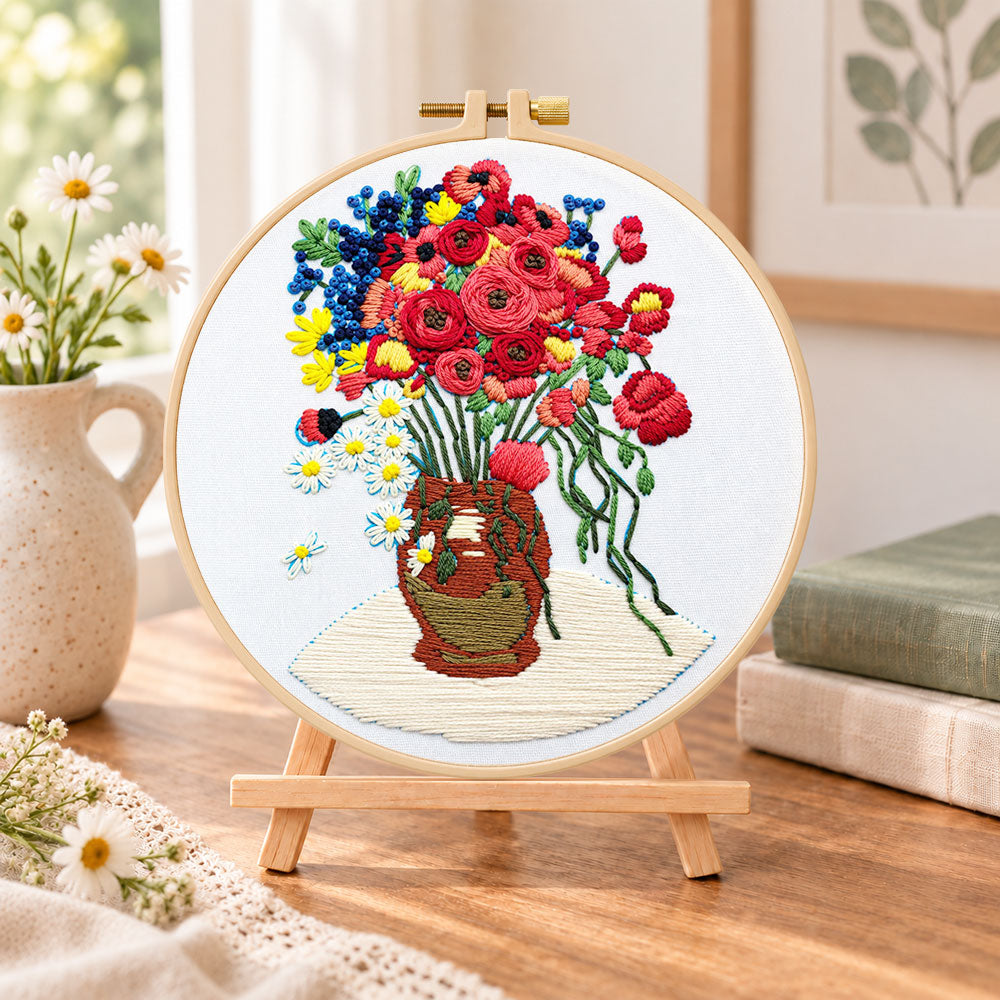 Vibrant bouquet in vase embroidery kit finished hoop displayed on a wooden stand as cozy tabletop decor