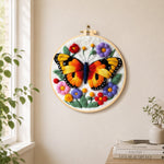 Vibrant butterfly and flowers needle felt wall art displayed in a bright home interior