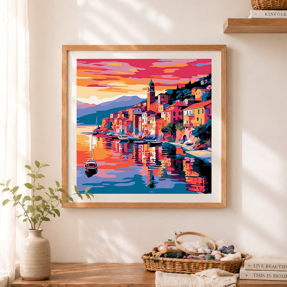 Finished vibrant coastal village cross stitch artwork displayed as home decor