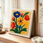 Vibrant colorful florals punch needle artwork displayed on a table