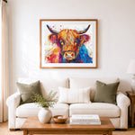 Finished vibrant highland cow splash art cross stitch artwork displayed as home decor