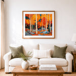 Finished vibrant orange autumn birch forest cross stitch artwork displayed as home decor