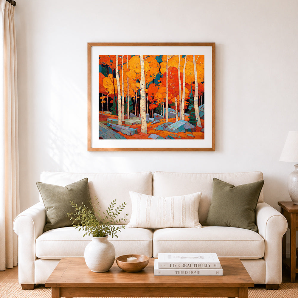 Finished vibrant orange autumn birch forest cross stitch artwork displayed as home decor