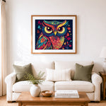 Finished vibrant patterned owl cross stitch artwork displayed as home decor