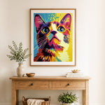 Finished vibrant pop art cat cross stitch artwork displayed as home decor