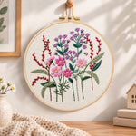 Vibrant purple floral embroidery hoop wall art displayed as warm and cozy handmade home decor