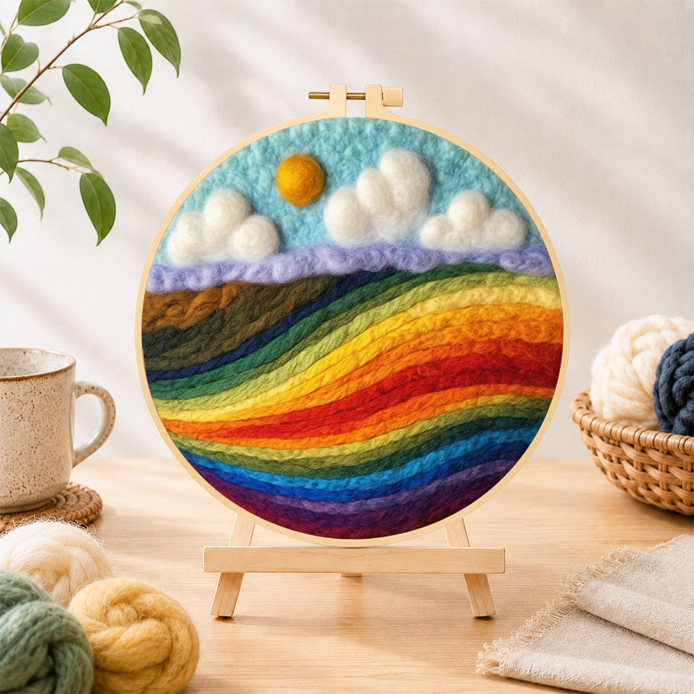 Finished vibrant rainbow color block landscape needle felting displayed on a wooden easel