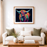Finished vibrant splash highland cow cross stitch artwork displayed as home decor