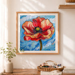 Finished vibrant swirling red poppy cross stitch artwork displayed as home decor