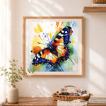 Finished vibrant watercolor butterfly cross stitch artwork displayed as home decor