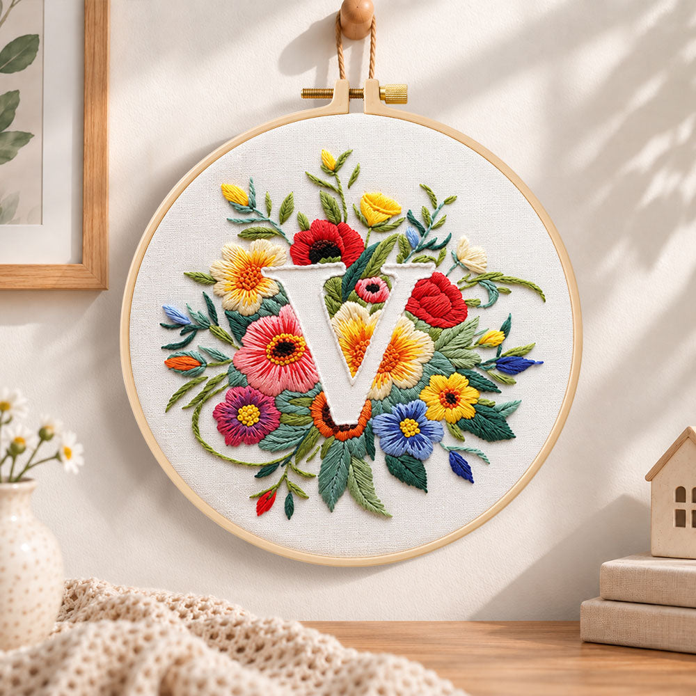 Vibrant wildflowers and letter v embroidery hoop wall art displayed as warm and cozy handmade home decor
