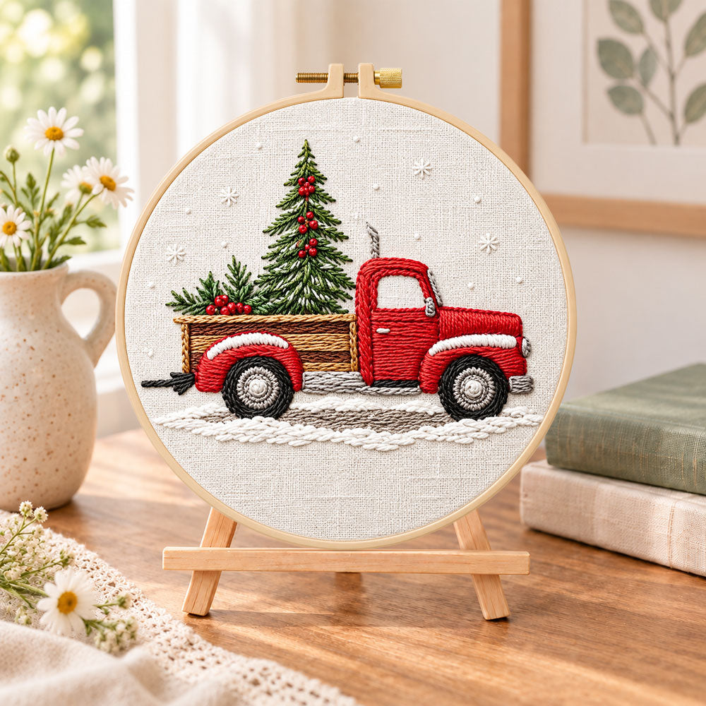Vintage red truck embroidery kit finished hoop displayed on a wooden stand as cozy tabletop decor