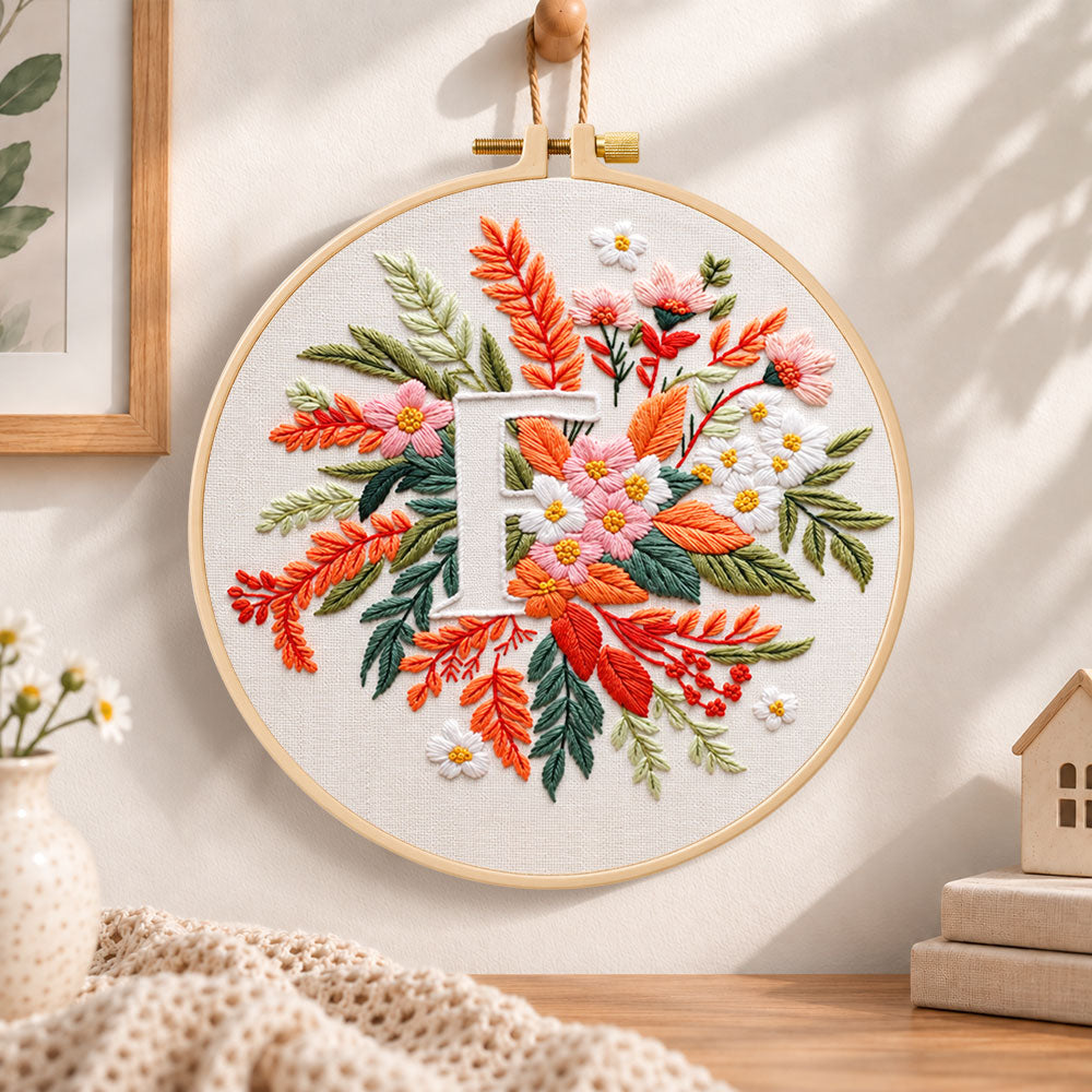 Warm autumn foliage and letter f embroidery hoop wall art displayed as warm and cozy handmade home decor