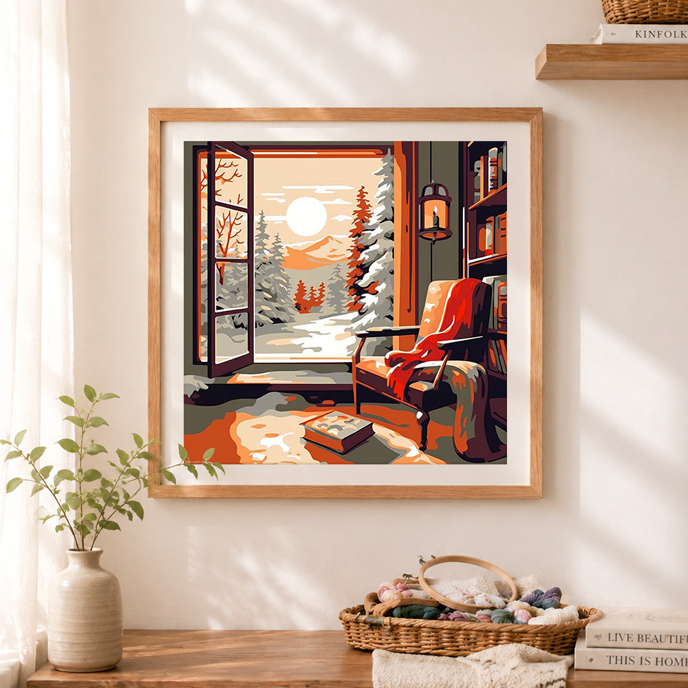 Finished warm indoor winter view cross stitch artwork displayed as home decor
