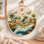 Warm sunlit village embroidery hoop wall art displayed as warm and cozy handmade home decor