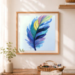 Finished watercolor multicolor feather cross stitch artwork displayed as home decor