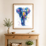 Finished watercolor rainbow elephant cross stitch artwork displayed as home decor