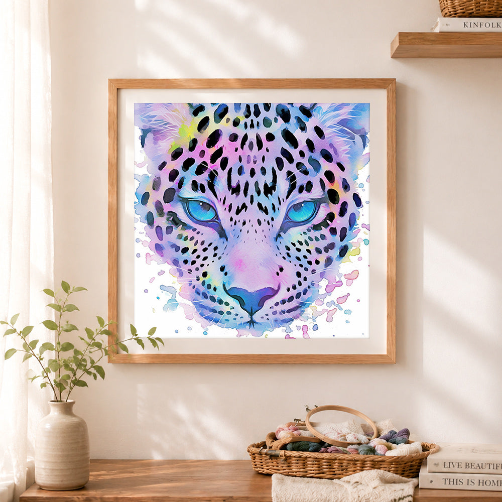 Finished watercolor rainbow leopard cross stitch artwork displayed as home decor