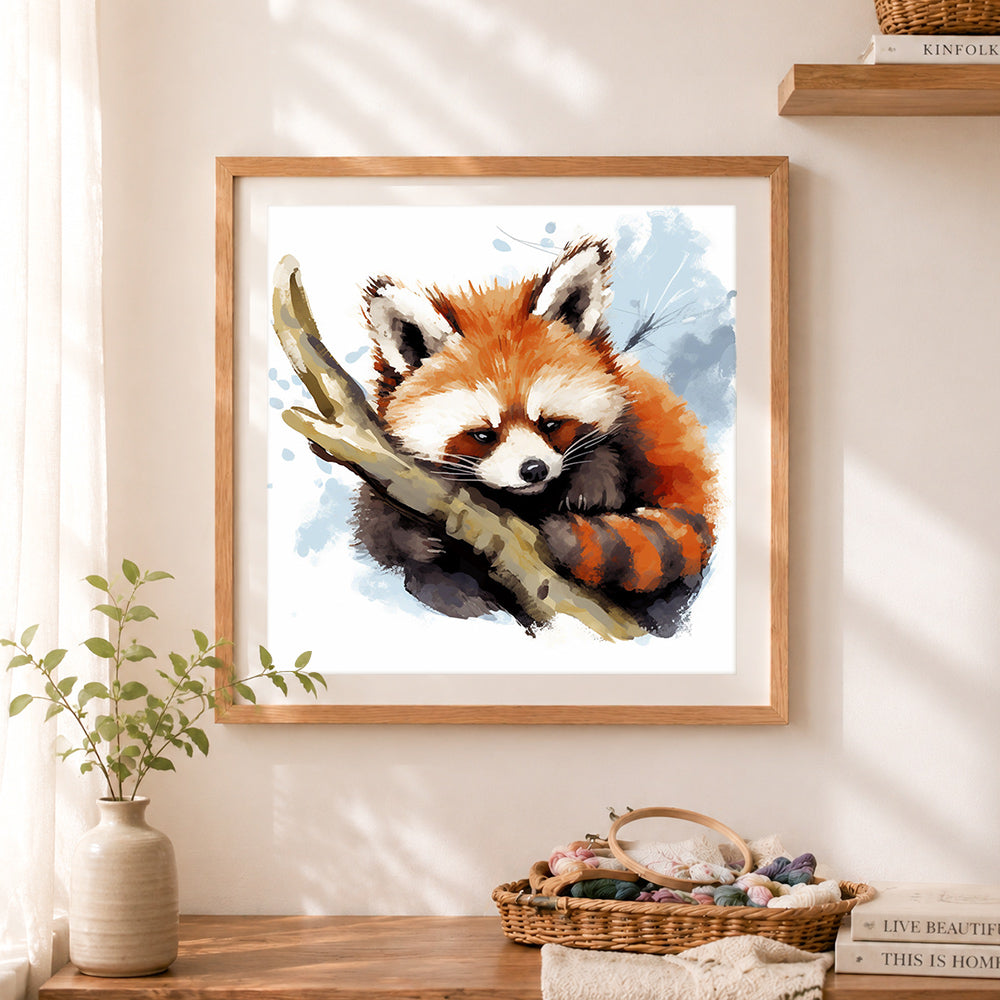 Finished watercolor red panda cross stitch artwork displayed as home decor