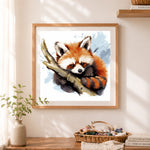 Finished watercolor red panda cross stitch artwork displayed as home decor