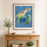 Finished watercolor sea turtle cross stitch artwork displayed as home decor