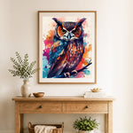 Finished watercolor splatter owl on branch cross stitch artwork displayed as home decor