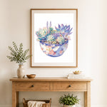 Finished watercolor succulent arrangement cross stitch artwork displayed as home decor