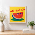 Finished watermelon with cute face artwork displayed on a wall