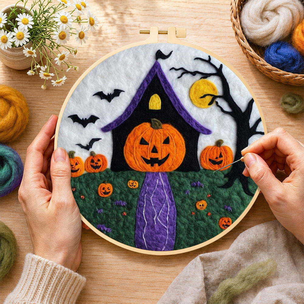 Creating the weird pumpkin head house wool painting by hand with a felting needle