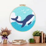 Finished whale and waves artwork displayed on a wall