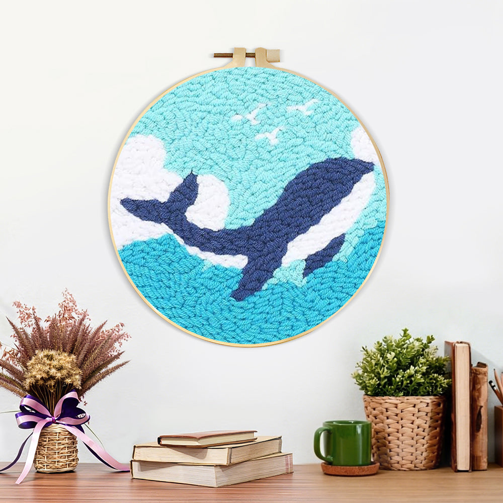 Finished whale and waves artwork displayed on a wall
