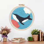 Finished whale swimming under the sea artwork displayed on a wall