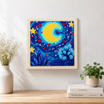 Finished whimsical crescent moon, stars and crystal tree artwork displayed on a wall