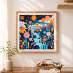 Finished whimsical floral waterfall scene cross stitch artwork displayed as home decor